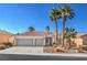 Charming home featuring a three-car garage, desert landscaping and mature palm trees at 10649 Bella Ordaz Way, Las Vegas, NV 89141