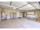 Spacious garage offering epoxy flooring, storage cabinets, and a convenient work bench at 10649 Bella Ordaz Way, Las Vegas, NV 89141
