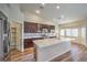 Modern kitchen featuring stainless steel appliances, large island with seating, and pantry at 10649 Bella Ordaz Way, Las Vegas, NV 89141