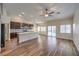 Open-concept kitchen boasts dark cabinets, granite countertops, and stainless steel appliances at 10649 Bella Ordaz Way, Las Vegas, NV 89141