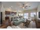 Cozy living room open to kitchen features modern furnishings and hardwood flooring at 10649 Bella Ordaz Way, Las Vegas, NV 89141
