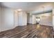 Spacious living room with wood-look flooring, modern lighting, and neutral paint at 10649 Bella Ordaz Way, Las Vegas, NV 89141