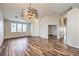 Open-concept living space featuring wood-look tile and contemporary lighting fixture at 10649 Bella Ordaz Way, Las Vegas, NV 89141