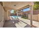Covered patio overlooking a refreshing swimming pool and landscaped backyard at 10649 Bella Ordaz Way, Las Vegas, NV 89141