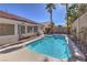 Backyard pool with a tanning ledge set amongst lush landscaping and a backyard spa at 10649 Bella Ordaz Way, Las Vegas, NV 89141