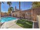 Inviting pool with an artificial turf area offering a great backyard retreat at 10649 Bella Ordaz Way, Las Vegas, NV 89141