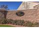 Close-up of the community's name on a brick wall with green landscaping at 10649 Bella Ordaz Way, Las Vegas, NV 89141