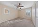 The carpeted bedroom features a ceiling fan, neutral walls, and two windows with plantation shutters at 1162 Paradise Desert Ave, Henderson, NV 89002