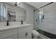 Modern bathroom features double vanity, sleek fixtures, and a glass-enclosed shower with stylish tile work at 1634 Serenada Ave, Las Vegas, NV 89169