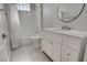 Updated bathroom boasts a sleek white vanity with a vessel sink, and tiled shower with a shower curtain at 1700 Hills Of Red Dr # 202, Las Vegas, NV 89128