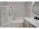 Updated bathroom featuring sleek white vanity with a vessel sink, tiled shower, and soaking tub at 1700 Hills Of Red Dr # 202, Las Vegas, NV 89128