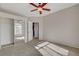 Bright bedroom with ceiling fan, carpet, and mirrored closet doors at 1700 Hills Of Red Dr # 202, Las Vegas, NV 89128