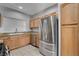 Bright kitchen featuring stainless steel appliances, wood cabinetry, and granite countertops at 1700 Hills Of Red Dr # 202, Las Vegas, NV 89128