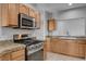 Well-equipped kitchen featuring modern appliances, stone countertops, and a clean and bright design at 1700 Hills Of Red Dr # 202, Las Vegas, NV 89128