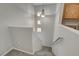 Clean staircase with carpeted steps, bright overhead lighting, and a modern design in neutral tones at 1700 Hills Of Red Dr # 202, Las Vegas, NV 89128