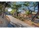 Scenic walking path surrounded by lush greenery and mature trees at 1700 Hills Of Red Dr # 202, Las Vegas, NV 89128