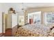 View of the main bedroom showcasing the flooring, ceiling fan, and a glimpse into the ensuite bathroom at 198 Adomeit Dr, Henderson, NV 89074