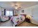 Bedroom with floral bedding, ceiling fan, and chair at 2173 Aspen Mirror Way # 101, Laughlin, NV 89029