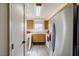 Galley kitchen with light wood cabinets and appliances at 2173 Aspen Mirror Way # 101, Laughlin, NV 89029