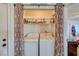 Laundry room with washer, dryer, and shelving at 2173 Aspen Mirror Way # 101, Laughlin, NV 89029
