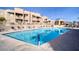 Large community pool with plenty of lounge chairs and patio space at 2173 Aspen Mirror Way # 101, Laughlin, NV 89029