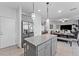 Modern kitchen with gray cabinets, granite island, and stainless steel appliances at 2212 Mystic Wave Rd, North Las Vegas, NV 89031