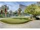 A putting green surrounded by mature landscaping at 222 Karen Ave # 1005, Las Vegas, NV 89109