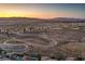 Aerial view of a residential area with a winding road and city skyline in the distance at 2920 Josephine Dr, Henderson, NV 89044