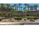 Welcoming gated community entrance with lush landscaping, palm trees, and serene water features, offering exclusivity and security at 2920 Josephine Dr, Henderson, NV 89044