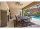 Covered patio with dining area, fireplace, and pool view at 2920 Josephine Dr, Henderson, NV 89044