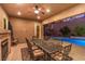 Covered patio with dining area, fireplace, and pool view at 2920 Josephine Dr, Henderson, NV 89044