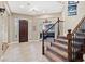 Elegant entryway with tiled floor, staircase, and access to Gathering room at 2920 Josephine Dr, Henderson, NV 89044
