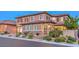 Tan house with shutters, stone accents and a three-car garage at 2920 Josephine Dr, Henderson, NV 89044