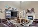 Spacious living room with high ceilings, fireplace, and large TV at 2920 Josephine Dr, Henderson, NV 89044