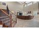 High-ceiling living room with a curved sectional sofa and fireplace at 2920 Josephine Dr, Henderson, NV 89044