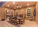 Covered outdoor patio area with dining table, chairs, fireplace, and well lit exterior at 2920 Josephine Dr, Henderson, NV 89044