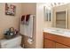 Cozy bathroom featuring oak vanity and an assortment of decorative towels and baskets at 3342 Pheasant Canyon Way # 1013, Laughlin, NV 89029