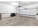 Spacious two-car garage with white walls and garage door at 3342 Pheasant Canyon Way # 1013, Laughlin, NV 89029