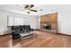 Living room with hardwood floors, a brick fireplace, and ceiling fan at 3701 Malner Ln, Las Vegas, NV 89130