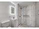 This modern bathroom features a tiled shower and lighted mirror at 4857 E Monroe Ave, Las Vegas, NV 89110