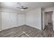 This bedroom features wood flooring, a ceiling fan, and large closets at 4857 E Monroe Ave, Las Vegas, NV 89110