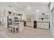 Well-lit kitchen featuring an island with seating, stainless steel appliances, and ample cabinetry at 5915 Ablette Ave, Las Vegas, NV 89122