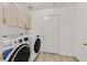 Laundry room with washer, dryer, and cabinets at 5915 Ablette Ave, Las Vegas, NV 89122