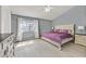 Large main bedroom with a king-size bed, ceiling fan, and attached bathroom at 5915 Ablette Ave, Las Vegas, NV 89122
