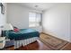 Bright bedroom with wood floors, a window, and a teal bedspread at 6083 Dunham Hills Way, Las Vegas, NV 89113