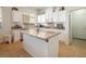 Large kitchen island with granite countertop and white cabinets at 6083 Dunham Hills Way, Las Vegas, NV 89113