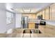 Well-lit kitchen features stainless steel appliances, granite countertops, tile floors and pantry at 6250 W Flamingo Rd # 98, Las Vegas, NV 89103