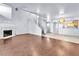 Open floor plan with a fireplace, staircase, wood floors, and adjacent kitchen at 6250 W Flamingo Rd # 98, Las Vegas, NV 89103
