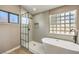 Bathroom with a walk-in shower and a modern freestanding tub at 6316 W Gowan Rd, Las Vegas, NV 89108