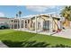 View of the backyard with artificial turf, a patio area and sunshade structure for enjoying the outdoors at 6409 Youngmont Ave, Las Vegas, NV 89103